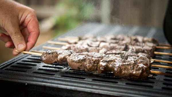 turning venison souvlaki on grill