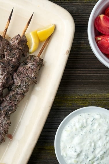 A platter of venison souvlaki with all the fixins.