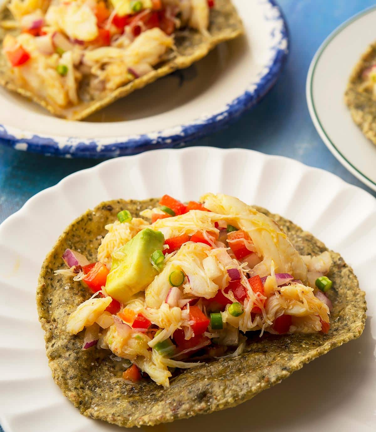 Crab ceviche tostadas on appetizer plates. 