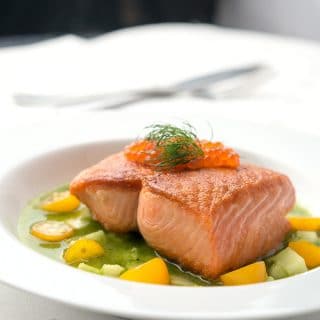 salmon with cucumber sauce on the plate
