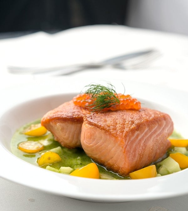 salmon with cucumber sauce on the plate