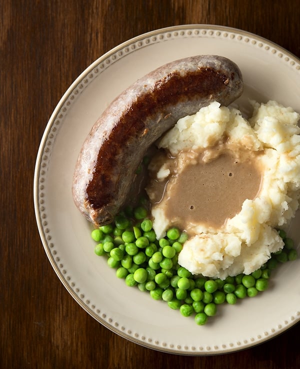 bangers and mash and peas on the plate
