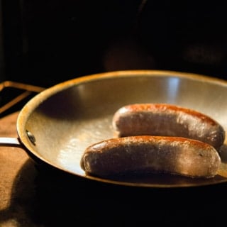 Bangers sausage roasting in the oven.