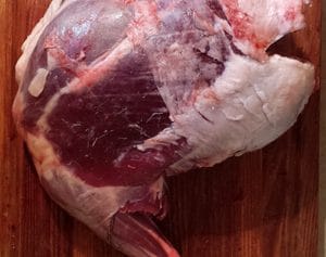 venison hind leg on a cutting board