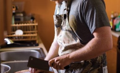 Hank Shaw chopping up duck feet for stock.