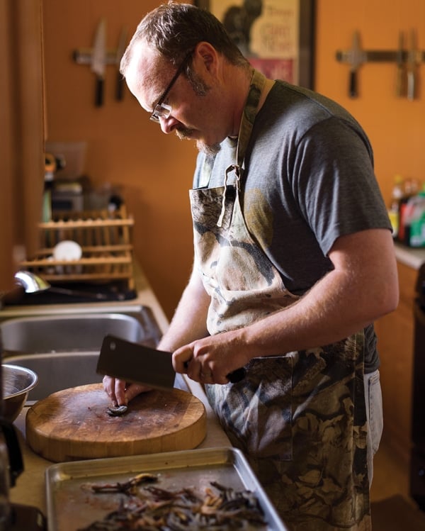 Hank Shaw chopping up duck feet for stock. 