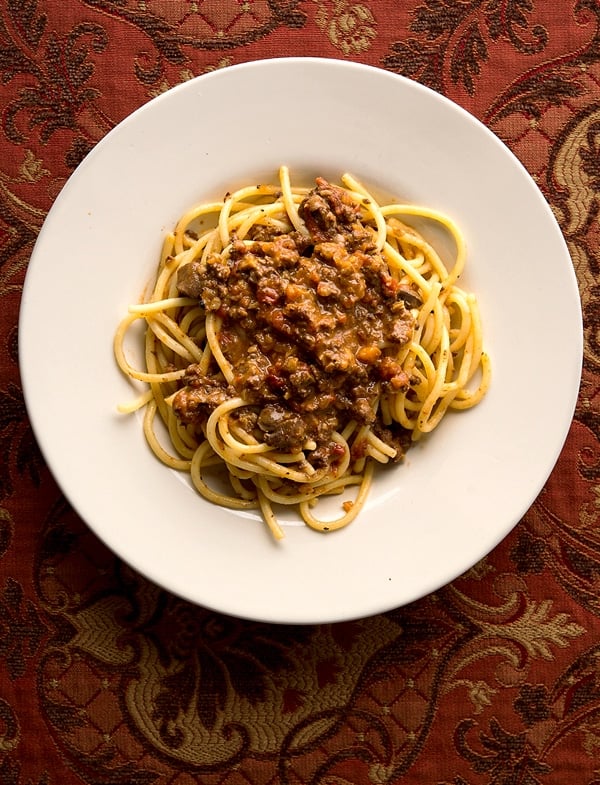 A plate of giblet bolognese with spaghetti. 