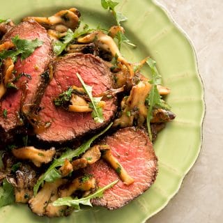 venison with caramelized onions on a plate