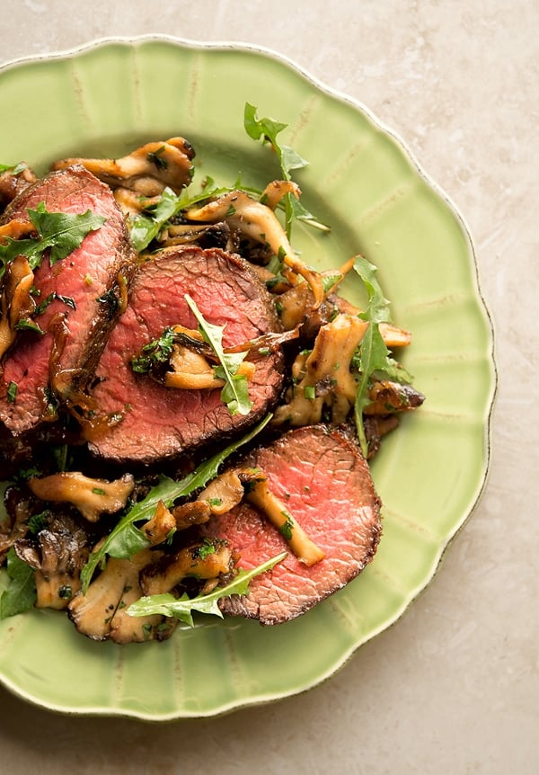 venison with caramelized onions on a plate