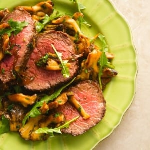 Venison steak with caramelized onions on a plate