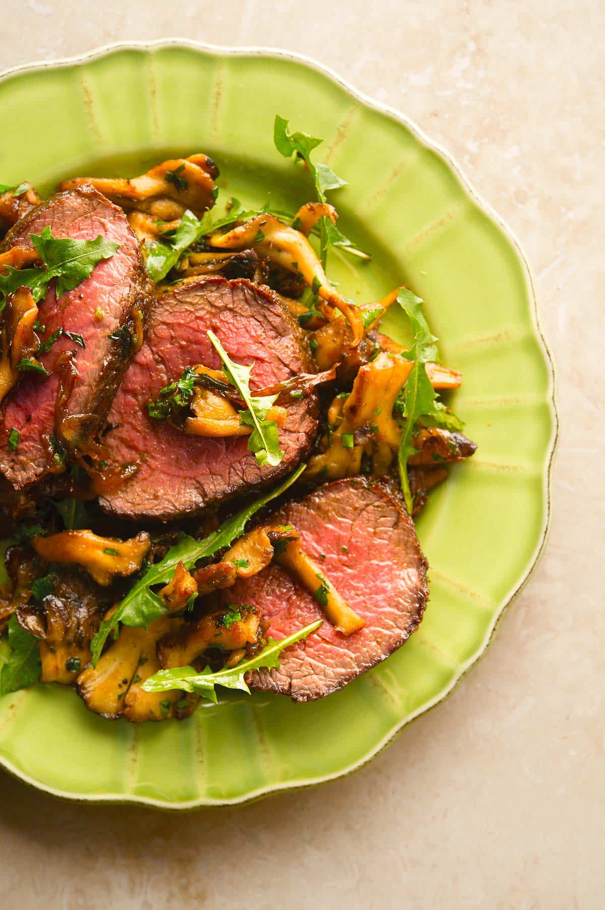 Venison steak with caramelized onions on a plate