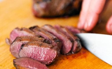 Finished duck breasts recipe on a cutting board.