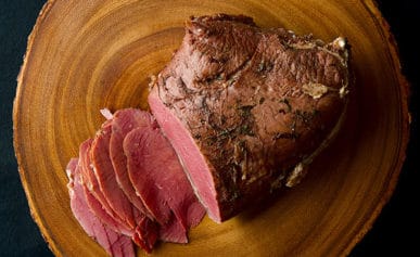 Corned venison on a cutting board.