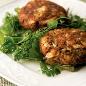 Midwestern fish cakes on a plate with a green salad.