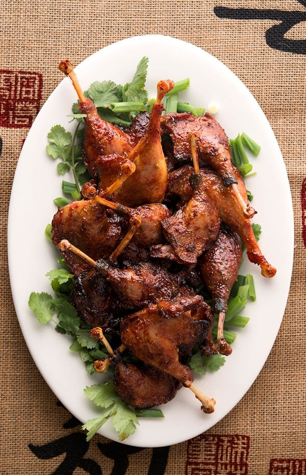 sriracha duck legs on a platter