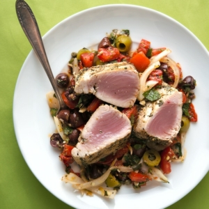 Grilled tuna steaks with Sicilian salad on a plate