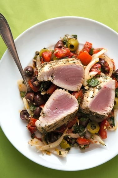 Grilled tuna steaks with Sicilian salad on a plate