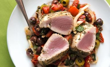 Grilled tuna steaks with Sicilian salad on a plate