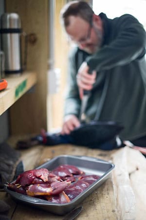 Hank Shaw cleaning a pukeko