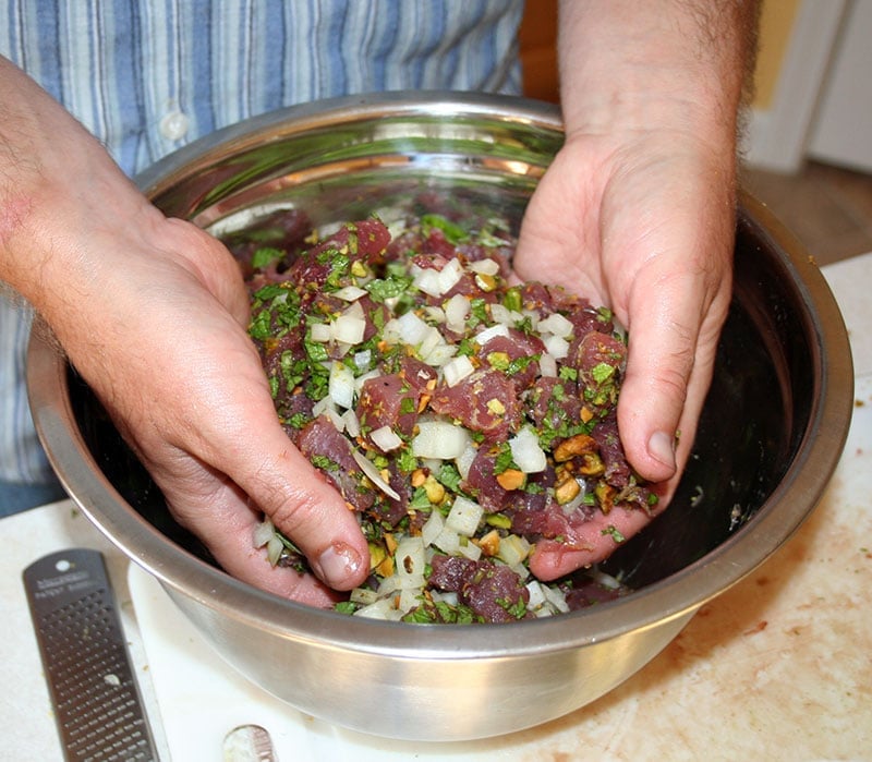 Mixing tuna meatballs in a bowl