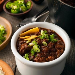A bowl of venison chili with toppings
