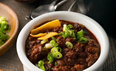 A bowl of venison chili with toppings