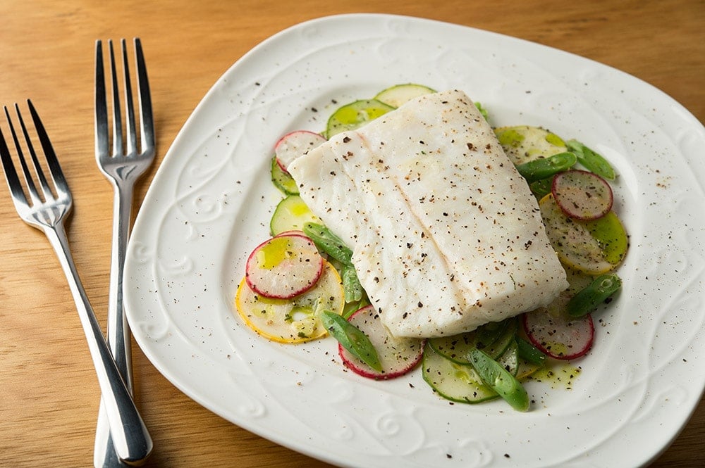 butter poached fish on the plate