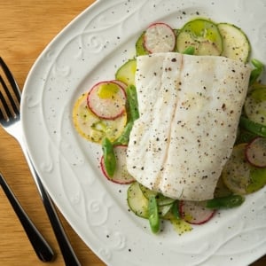 butter poached halibut on a summer salad