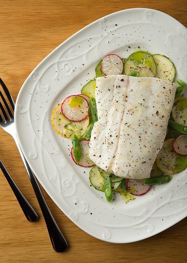 butter poached halibut on a summer salad