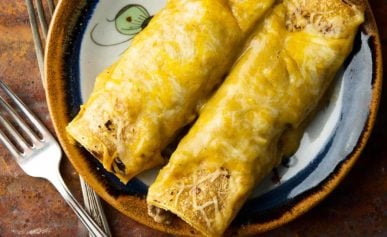 Two green chile enchiladas on a plate