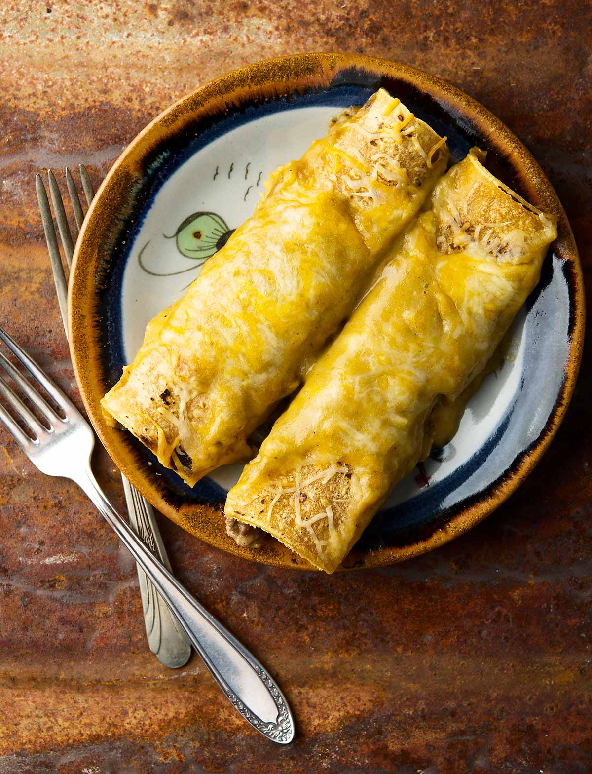 Two green chile enchiladas on a plate