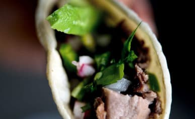 Holding a taco de lengua ready to eat