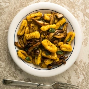 A bowl of butternut squash gnocchi with mushrooms
