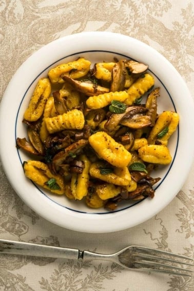 A bowl of butternut squash gnocchi with mushrooms