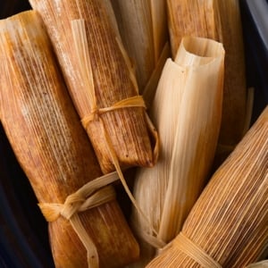 venison tamales wrapped in corn husks