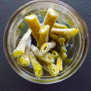 Candied angelica stems in a glass jar.