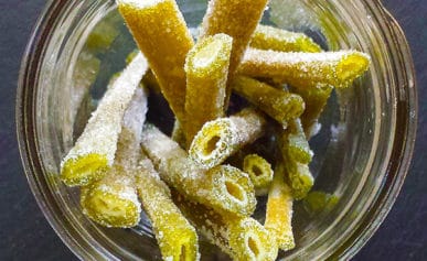 Candied angelica stems in a glass jar.