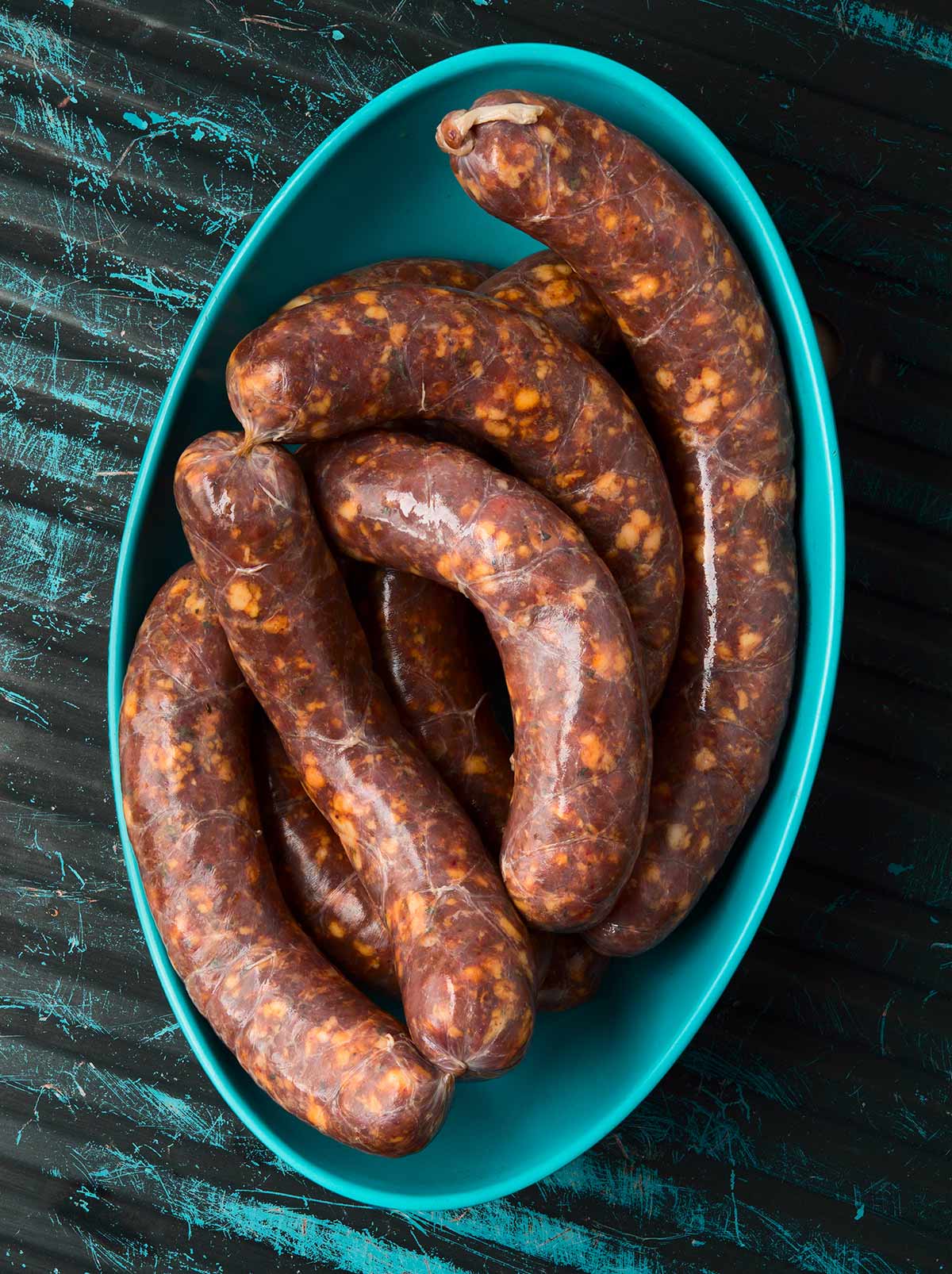 Links of spicy Italian sausage in a bowl