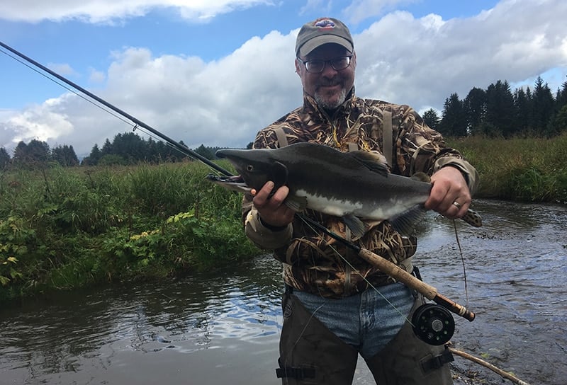 Hank Shaw holds his first ever fish caught on a fly, a pink salmon. 