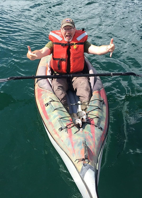 Hank Shaw with nice dolly varden in his kayak. 