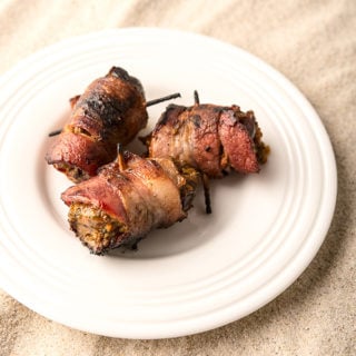 Bacon wrapped doves with dates on a plate