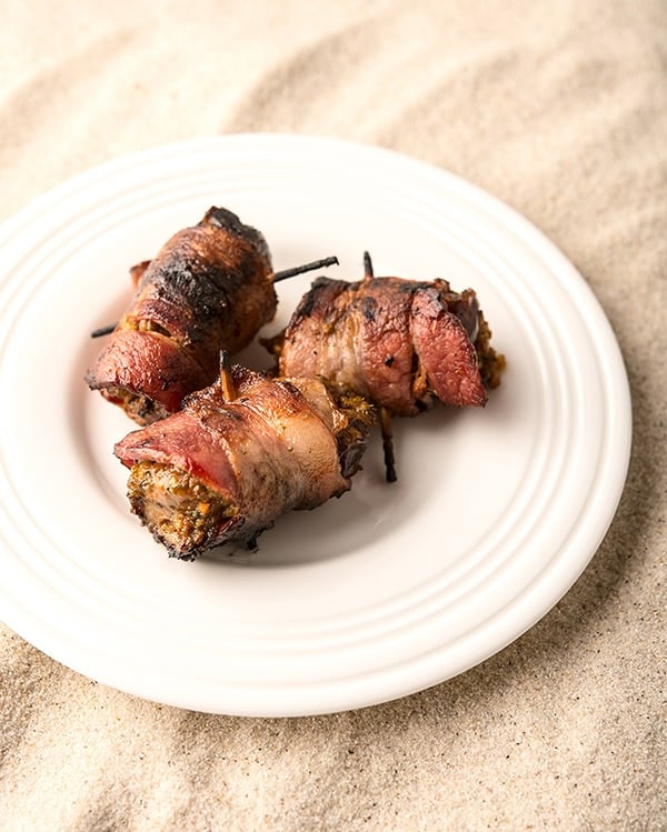 Bacon wrapped doves with dates on a plate