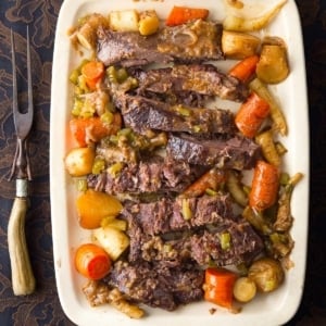 Venison pot roast made in a crock pot, served on a platter.