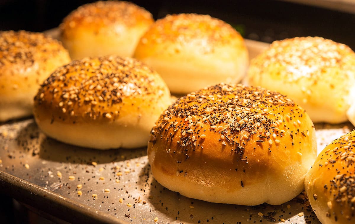 A row of bierocks on a baking sheet, fresh out of the oven. 