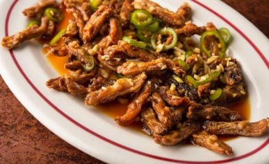 Crispy fried duck tongues on a platter.