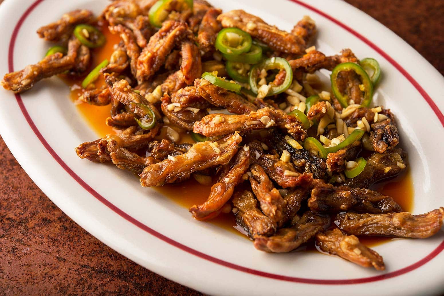 Crispy fried duck tongues on a platter. 