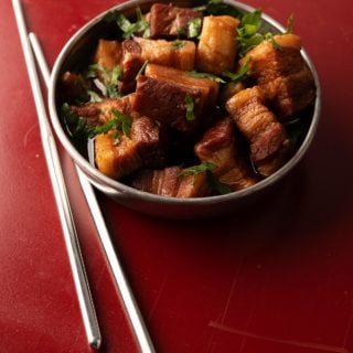 Chinese red pork in a bowl with chopsticks