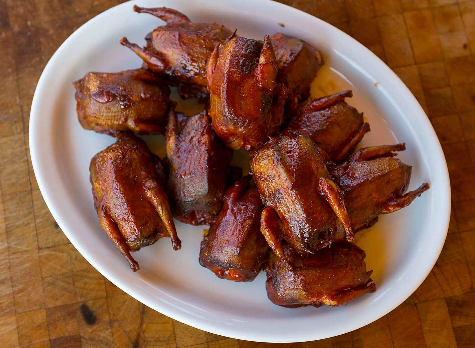 Slow barbecued doves on a platter. 