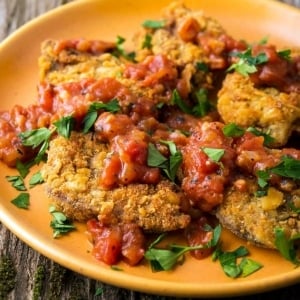 A plate of chicken fried steak with tomato gravy