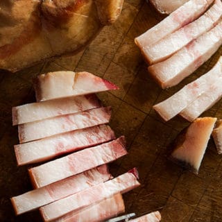 Sliced jowl bacon on cutting board